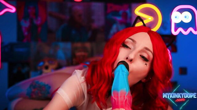 Redhead cosplay girl with cat ears sucks huge colorful dildo