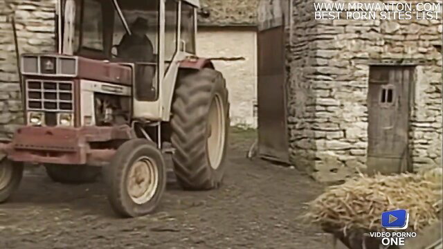 Farm girl in cab of red tractor, haystack behind, rural porno