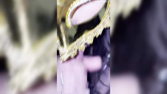 Blurry gold Venetian mask closeup on pale skin, mysterious masked woman