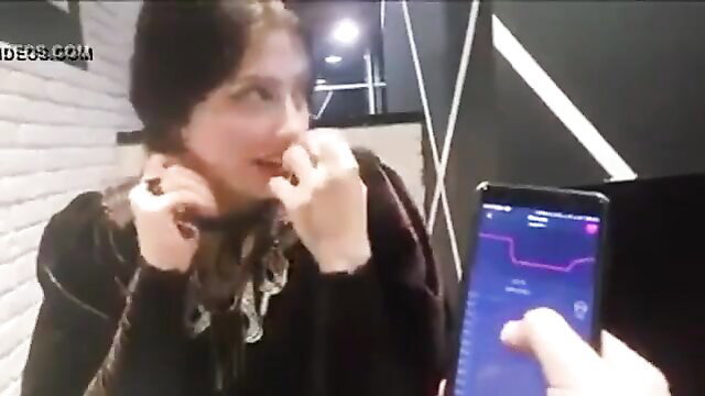 Cute brunette with remote sex toy buzzes in public, phone app tease