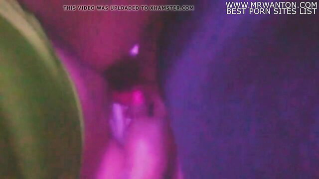 Blurry closeup of woman's wet pink pussy in purple lighting, dirty bitch solo