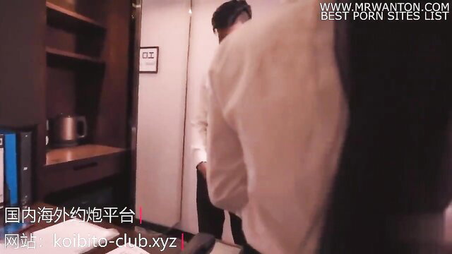 Asian man in white shirt stands in hotel room, JAV travel with leader scene