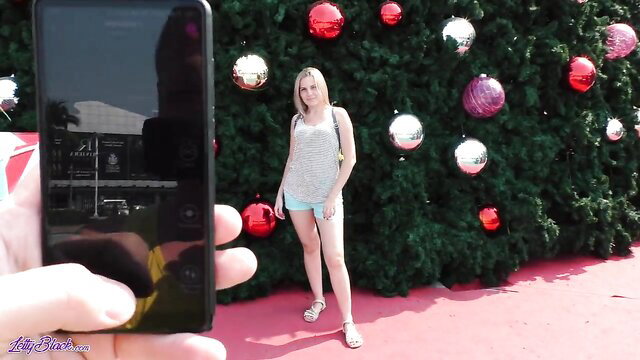 Letty Black poses sexy in tiny shorts by Christmas tree mall display