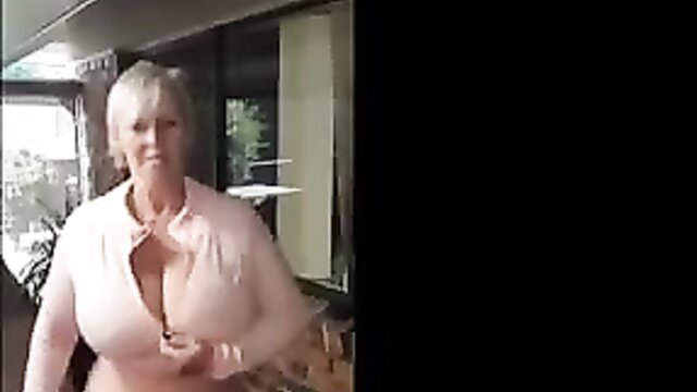 Busty mature blonde in deep cleavage pink blouse teasing indoors