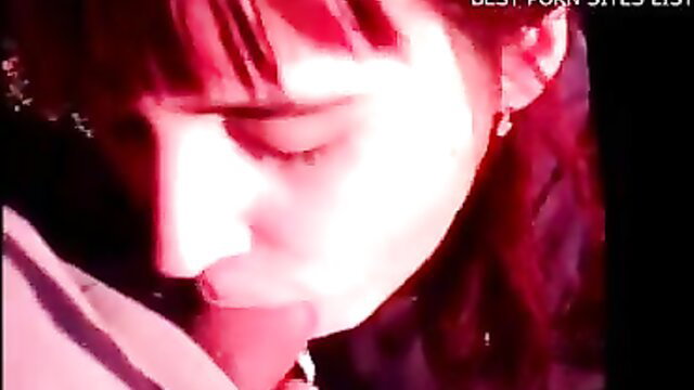 Closeup of seductive brunette with bangs in pink-lit erotic thumbnail