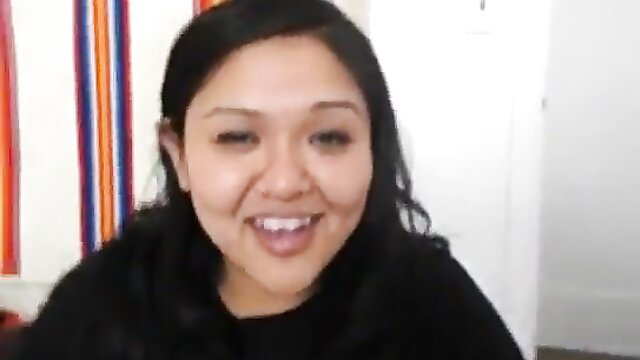 Smiling Asian BBW with black hair in casual top, closeup face