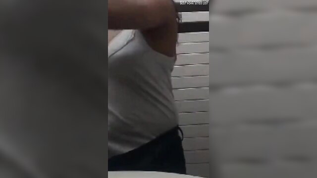 Indian Mallu girl in white tank top and black pants in bathroom