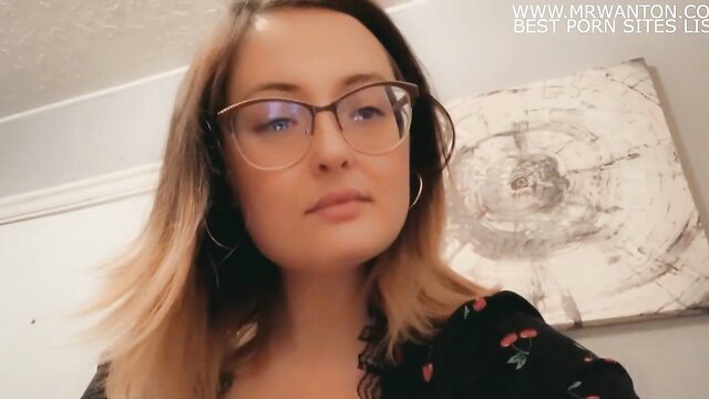 Hot blonde in glasses and floral dress teases with sultry gaze