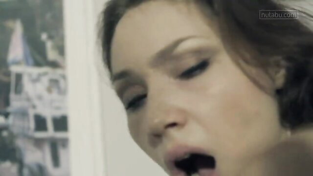 Closeup of aroused brunette woman with open mouth in lesbian creampie scene