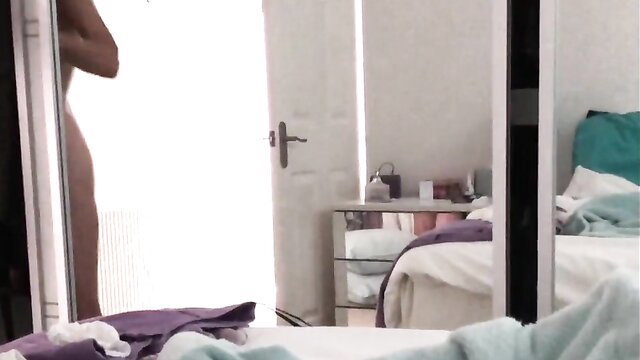 Nude wife Angela side view in bedroom before putting on bra and panties