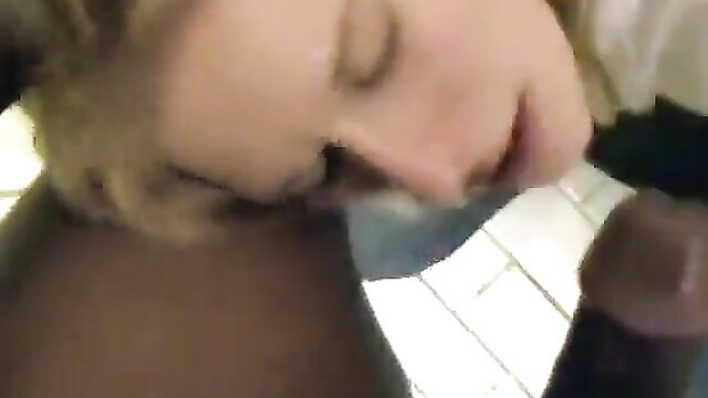 Blonde woman deepthroating huge black cock closeup