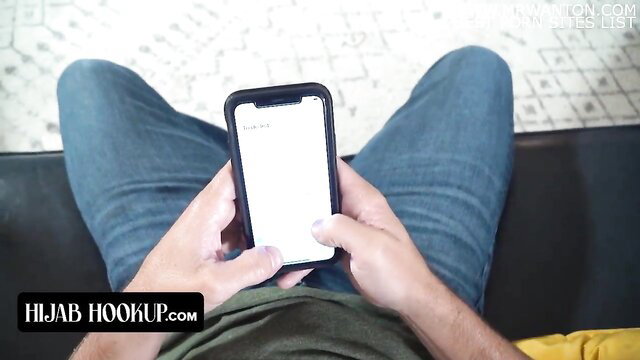 Arab guy in jeans holds phone, Hijab Hookup secret bro-sis BJ