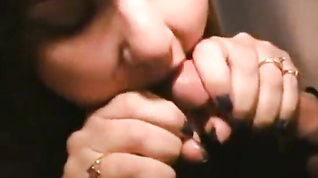 Closeup of girlfriend's hands stroking cock through glory hole