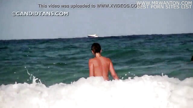 Naked Asian twink bathing in turquoise sea waves from behind