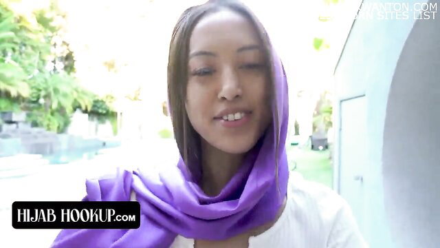Alexia Anders in purple hijab, teasing gaze outdoors