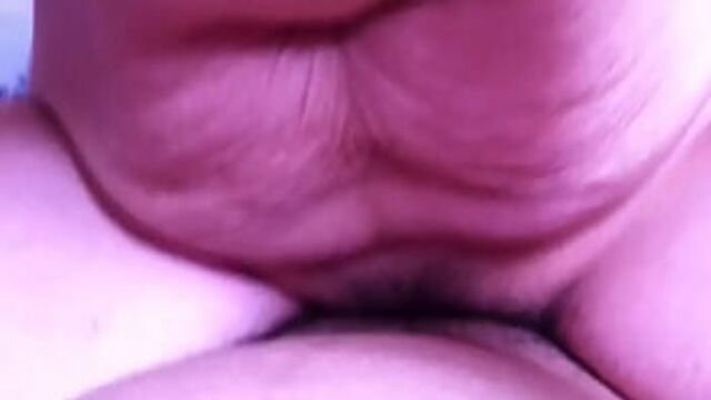 Closeup of big Thai widow's plump shaved pussy lips spread wide