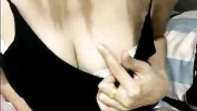 Blonde in black lingerie teases huge cleavage with fingers, amateur closeup