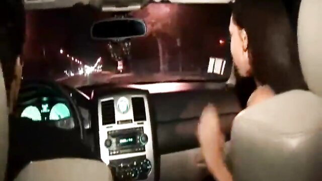 Hot Latina teen in car at night, hand on wheel, college party vibe