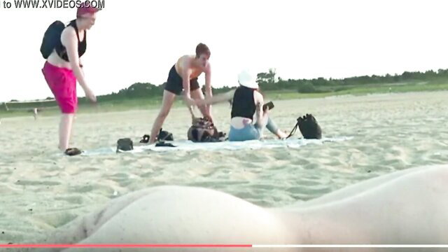 Man hands-free cums on nude girl's big ass at public beach with friends watching