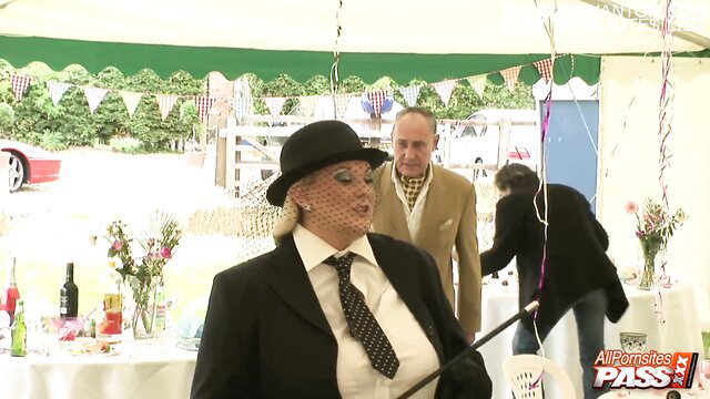 Katie Fox in suit and hat at outdoor public event orgy