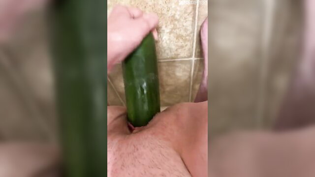 Woman shoving huge cucumber deep in wet pussy closeup