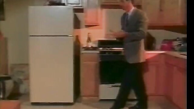 Man in suit cooking in kitchen, retro adult video thumbnail