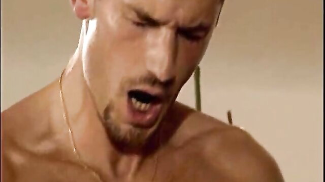 Muscular man with goatee in intense orgasm face closeup