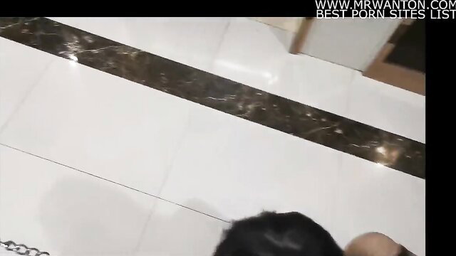 Chinese whore on knees in bathroom sucking cock closeup