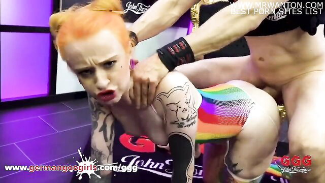 Tattooed redhead pale girl in doggy ass pose, body painted rainbow pig slut