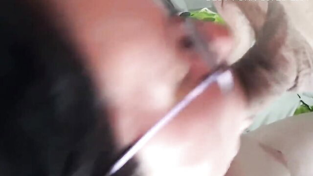 Man in glasses close-up with paw or hand on furry creature in adult scene