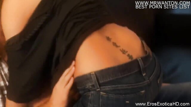 Lovely blonde teases with tattooed lower back in tight jeans