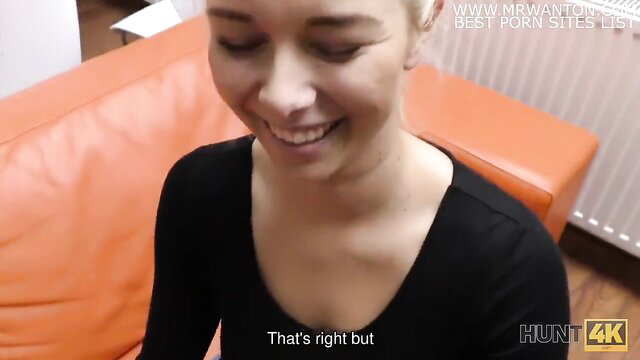 Blonde Hunt4K model smiles on orange couch in pickup video