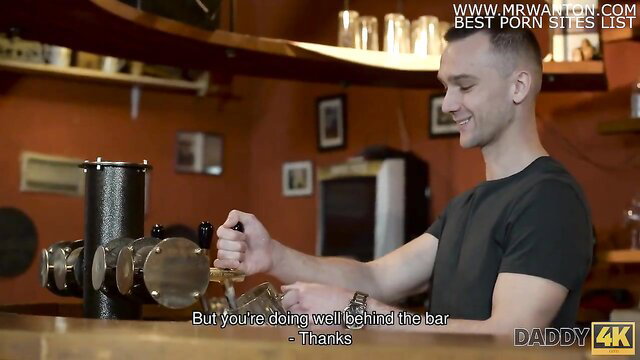 Anna Rose chats with bartender guy behind bar in Daddy4K video