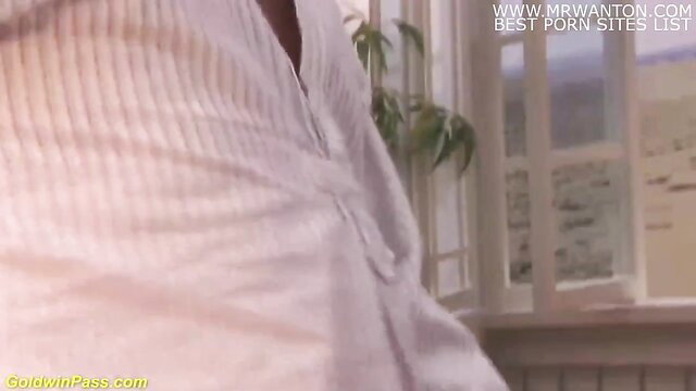 Busty Asian in tight sweater teases cleavage closeup