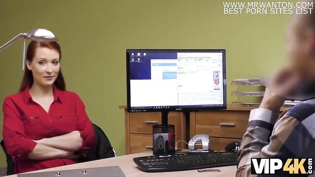 Redhead Isabella Lui in red blouse at desk in VIP4K scene