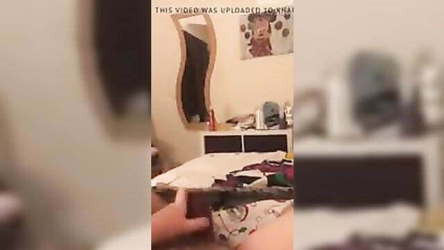 Amateur slut holding big cock in bedroom closeup