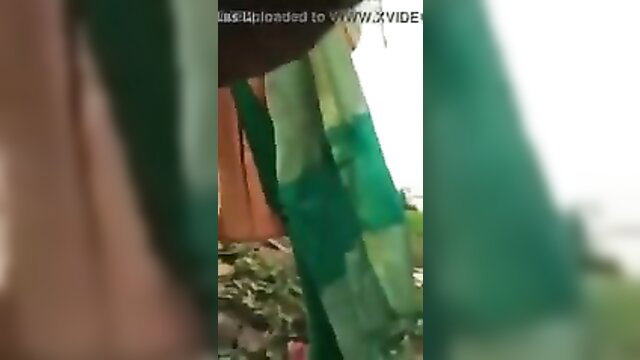Tamil Indian amateur women hanging colorful sarees outdoors