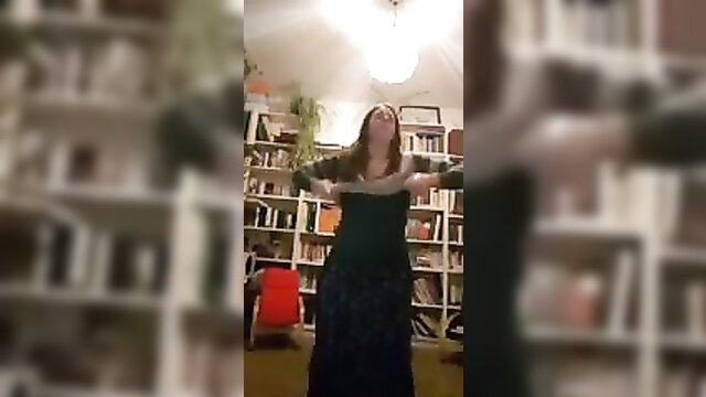 Curvy MILF in black dress stripping arms wide in library