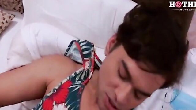 Indian Bhabhi in floral dress lying seductively on bed