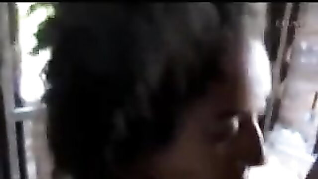 Closeup of black woman blowing smoke, amateur face view