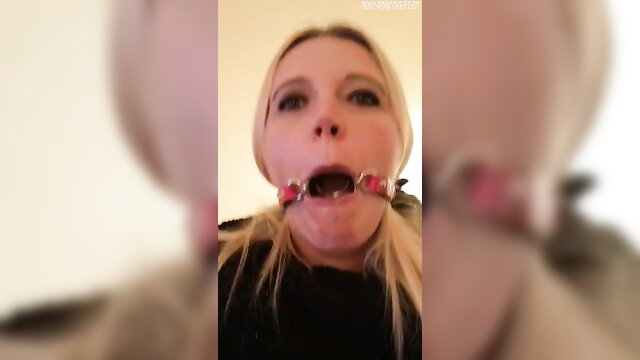 Blonde babe in FFP2 mask with pink ballgag drooling closeup