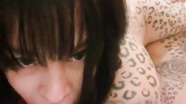 Closeup of tattooed brunette's intense face during hardcore fuck with fan