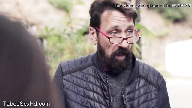 Bearded man in glasses talks to desperate tourist girl outdoors