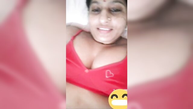 Busty Indian bhabhi in red lingerie smiling seductively