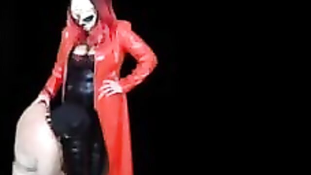Miss Terie in red latex coat teases leashed sub in CFNM femdom