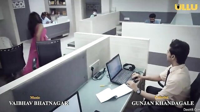 Indian office girl in pink saree with colleague at desk, Ullu web series