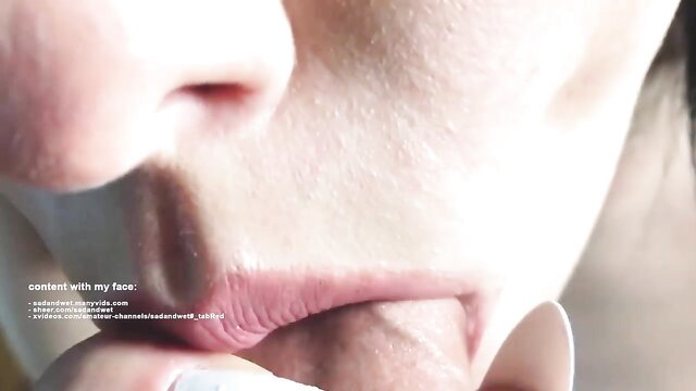 Close-up of Asian babe's wet open mouth and tongue in sloppy blowjob