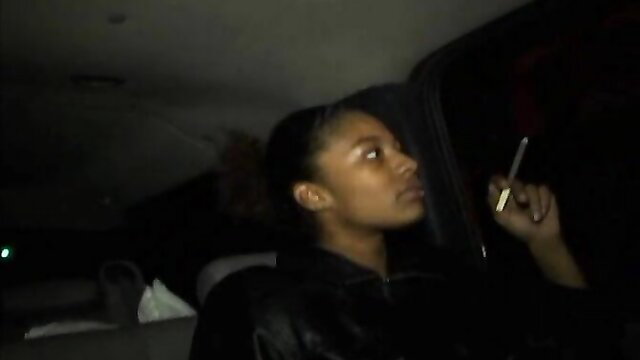 Ghetto black thot smoking in car, leather jacket profile view