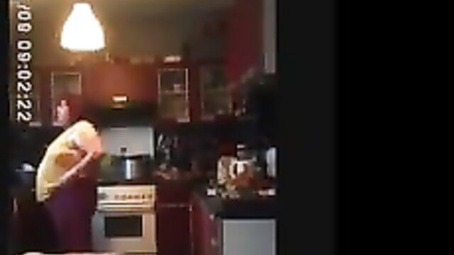 Cherie bent over kitchen counter in tight top and pants, amateur tease