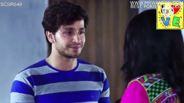 Handsome Indian guy smiling at pretty long-haired girl in colorful saree blouse